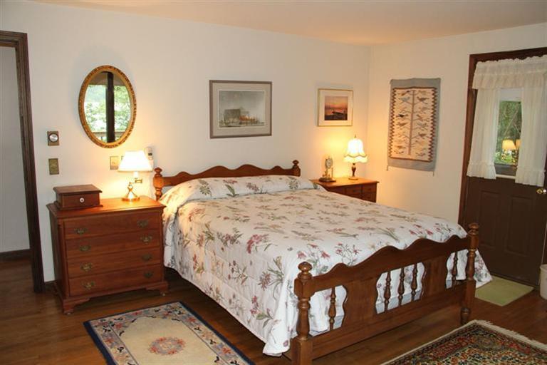 62 Turning Mill Road Brewster, MA 02631 - Photo 25 of 27 a bed sitting in a bedroom next to a window