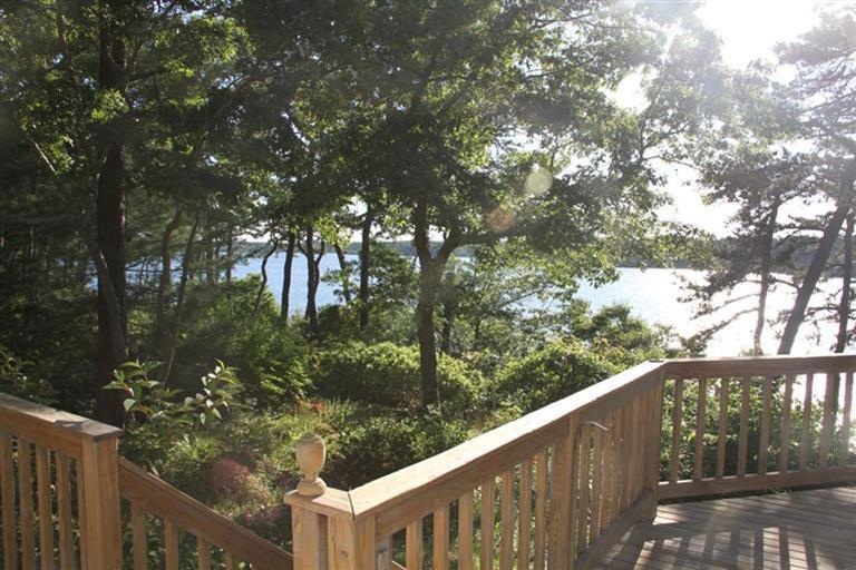 62 Turning Mill Road Brewster, MA 02631 - Photo 6 of 27 a balcony with wooden fence and trees