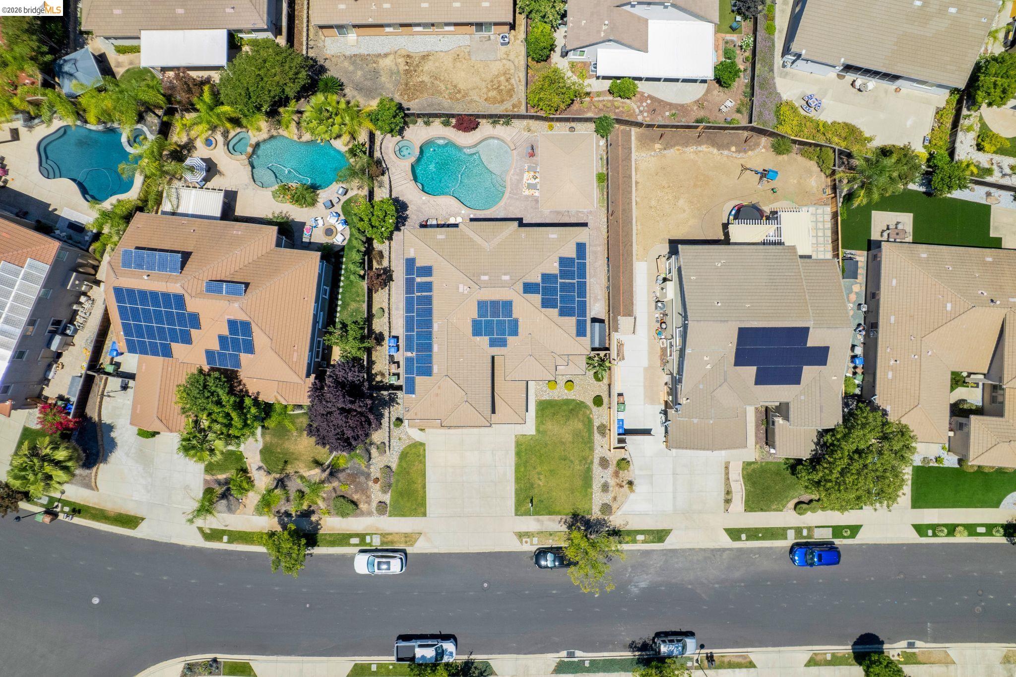 2513 Winged Foot Road Brentwood, CA 94513 - Photo 45 of 45 Tile roof property featuring extensive solar panel installations, a spacious driveway, and mature landscaping