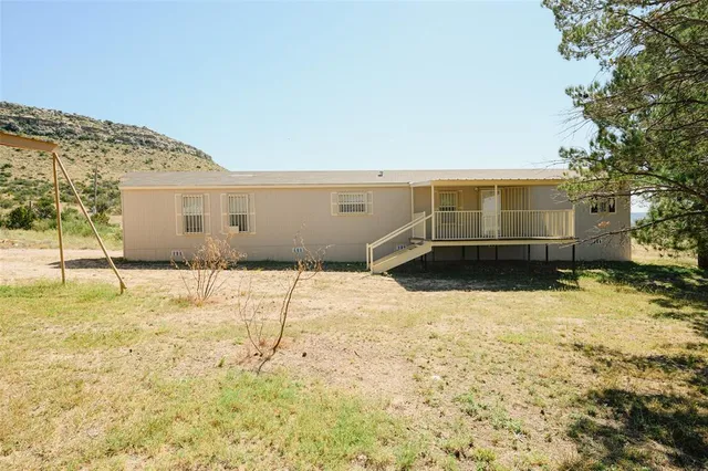 a kitchen with granite countertop a sink stove and cabinets