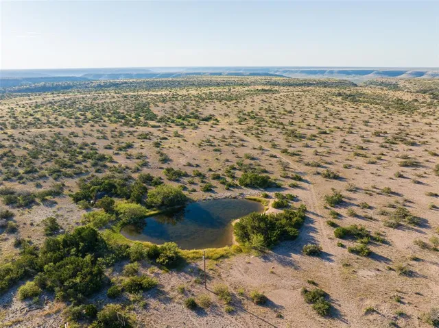 a bathroom with a granite countertop shower and a mirror