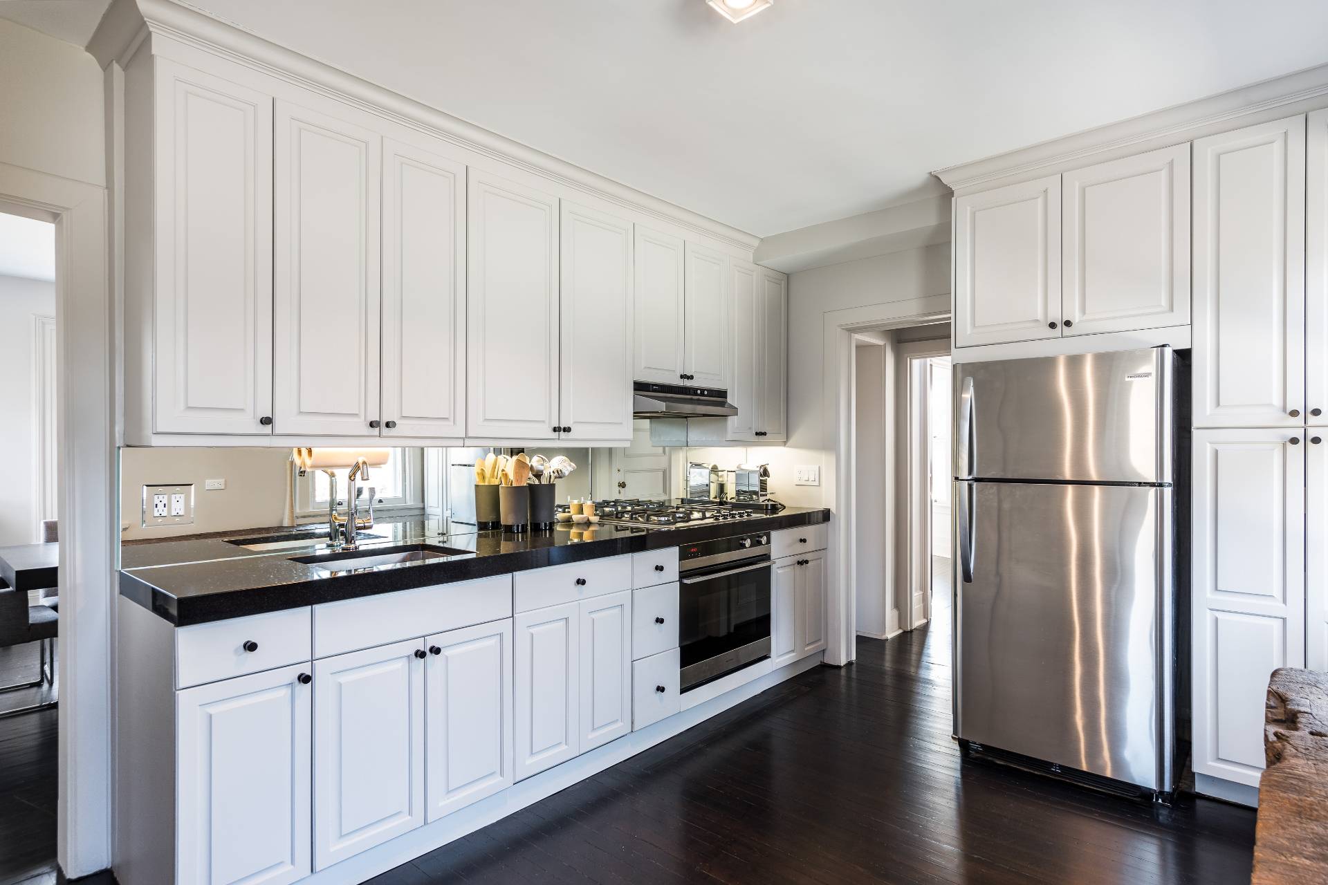 196 Maple Lane Bridgehampton, NY 11932 - Photo 17 of 25 a kitchen with granite countertop white cabinets and stainless steel appliances