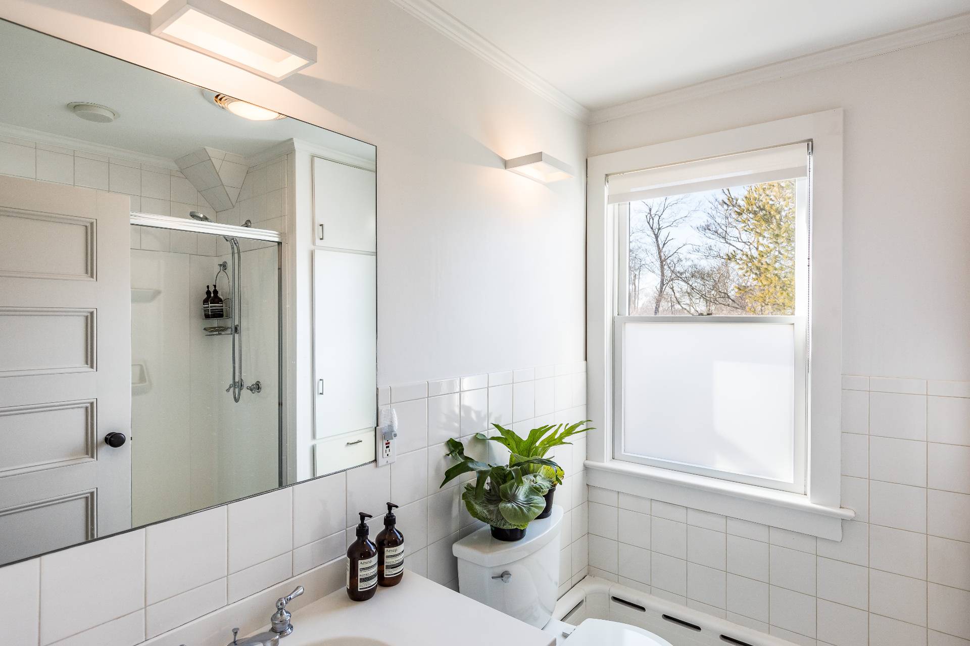 196 Maple Lane Bridgehampton, NY 11932 - Photo 25 of 25 a bathroom with a shower sink and a mirror