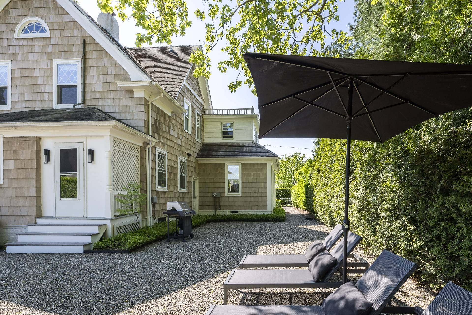 196 Maple Lane Bridgehampton, NY 11932 - Photo 7 of 25 a view of a small house with a yard