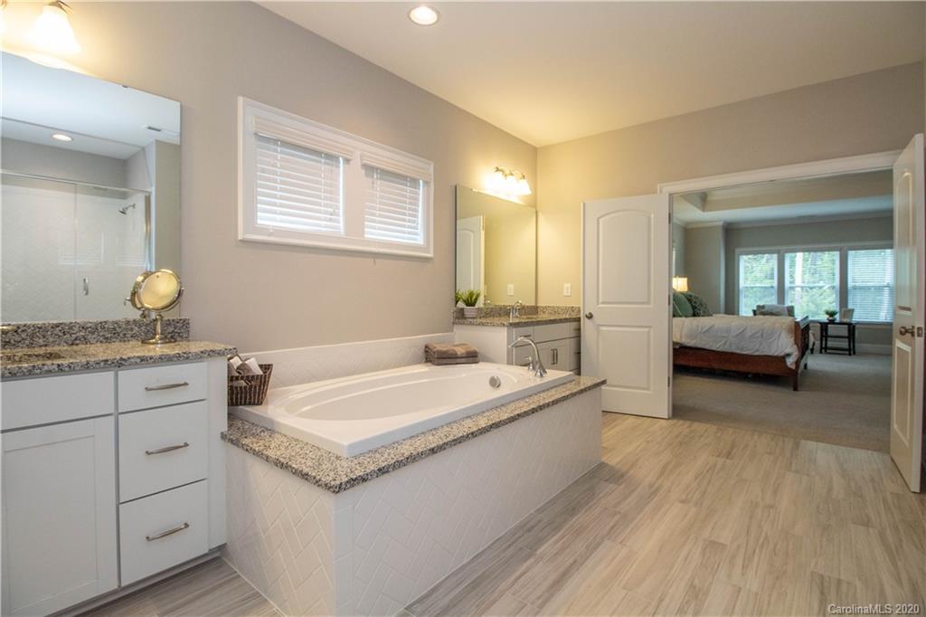 1428 Afton Way Fort Mill, SC 29708 - Photo 22 of 40 a spacious bathroom with a granite countertop tub sink and mirror
