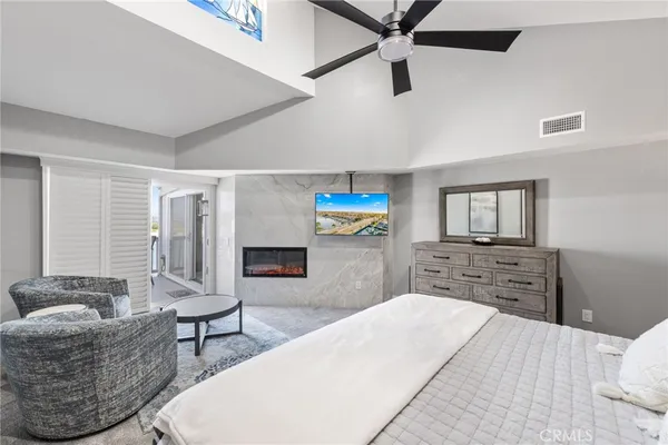 a bedroom with furniture and a wooden floor
