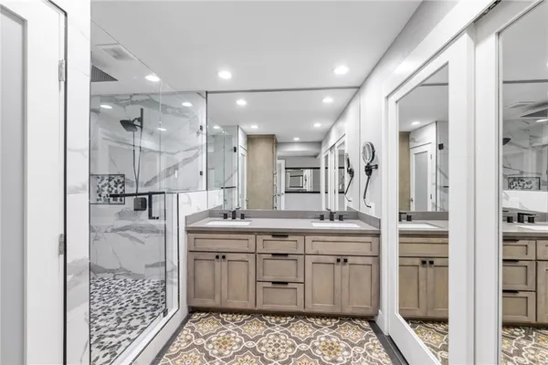 a bathroom with a double vanity sink a and a shower