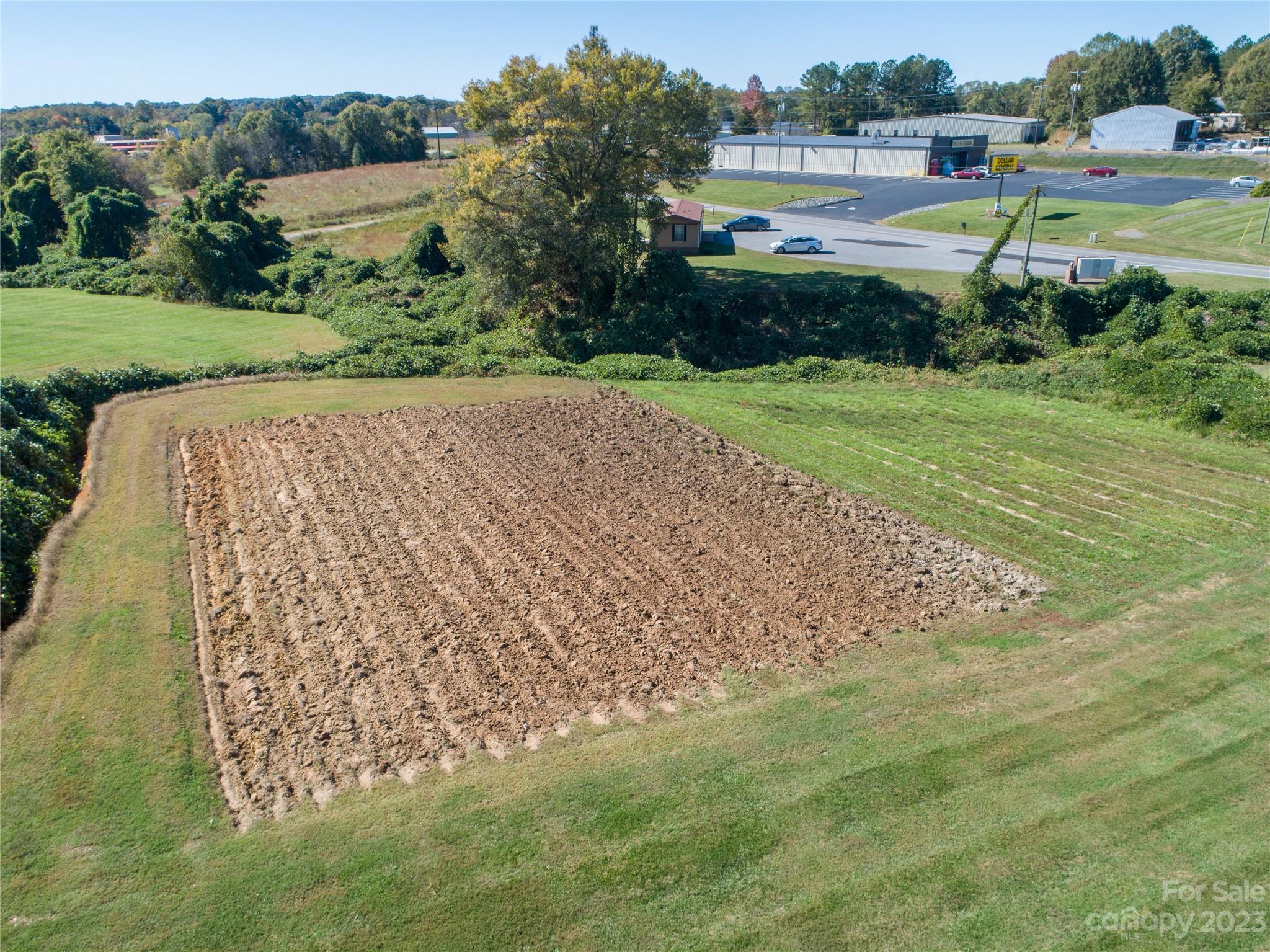 5090 Highway 90 Hiddenite, NC 28636 - Photo 15 of 17 a view of a garden with a building in the background