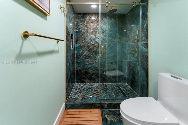 a bathroom with a toilet and a shower