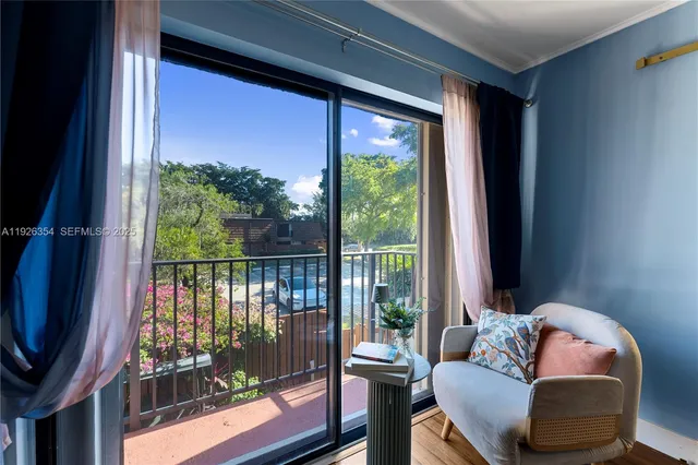 a living room with furniture and a floor to ceiling window