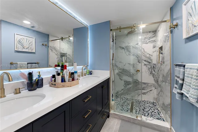 a bathroom with a double vanity sink mirror and shower