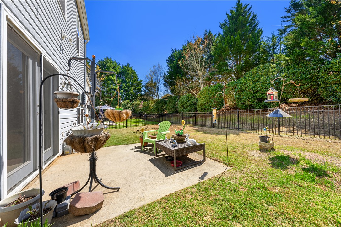 105 Ledgewood Way Easley, SC 29642 - Photo 27 of 35 This private yard offers a concrete patio, ideal for outdoor leisure.