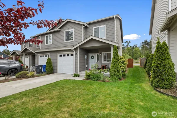 a front view of a house with a yard and porch
