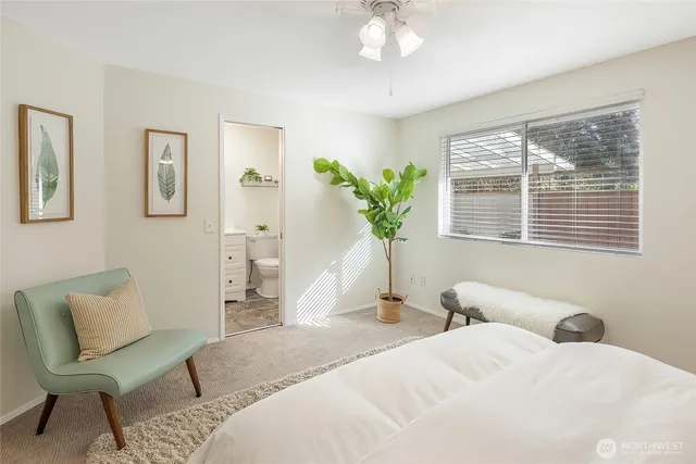 a bedroom with a bed and a chair