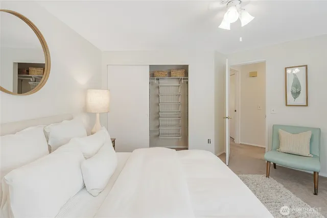 a bedroom with a bed and a lamp