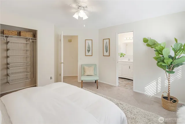 a bedroom with a bed and a potted plant