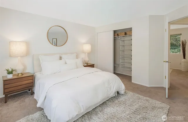 a bedroom with bed and a chandelier