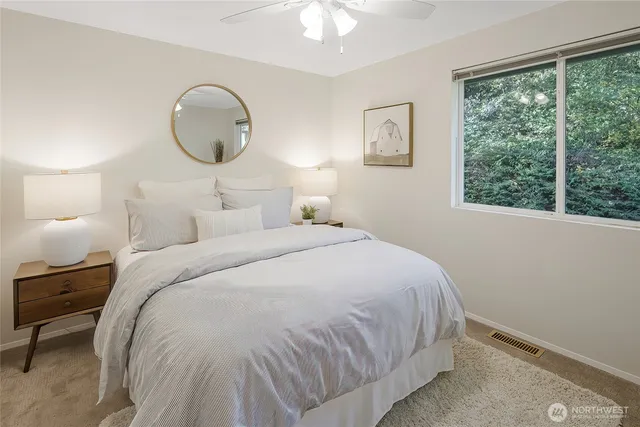 a bedroom with a bed and a large window