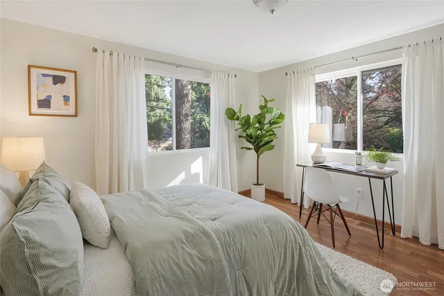 a bedroom with a bed and a large window