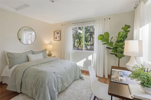 a bedroom with bed and a potted plant