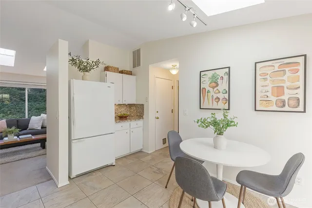 a kitchen with furniture and a refrigerator