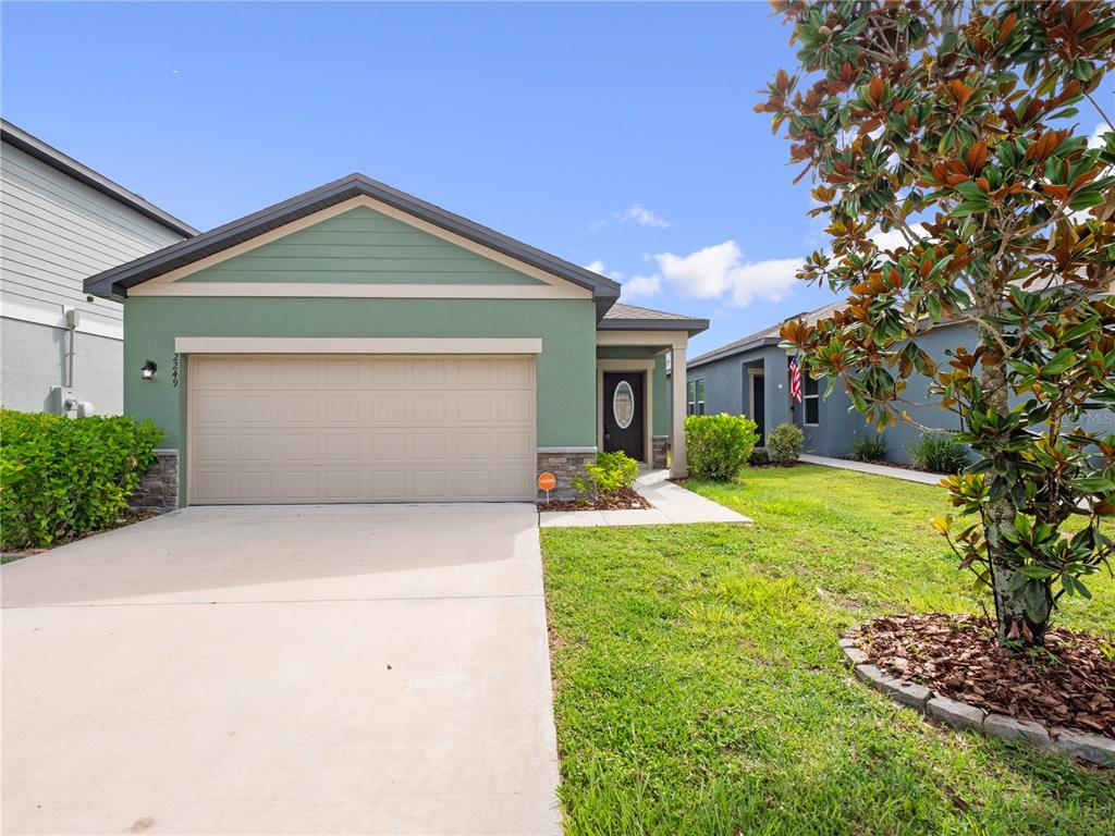2249 Litchfield Loop DeLand, FL 32720 - Photo 1 of 27 a front view of house with yard and trees