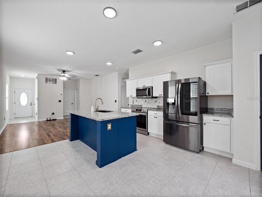 2249 Litchfield Loop DeLand, FL 32720 - Photo 12 of 27 a large kitchen with stainless steel appliances lots of counter top space