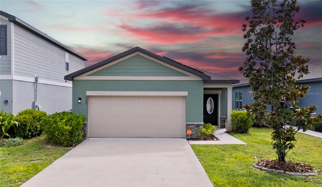 2249 Litchfield Loop DeLand, FL 32720 - Photo 27 of 27 a front view of a house with a yard and garage