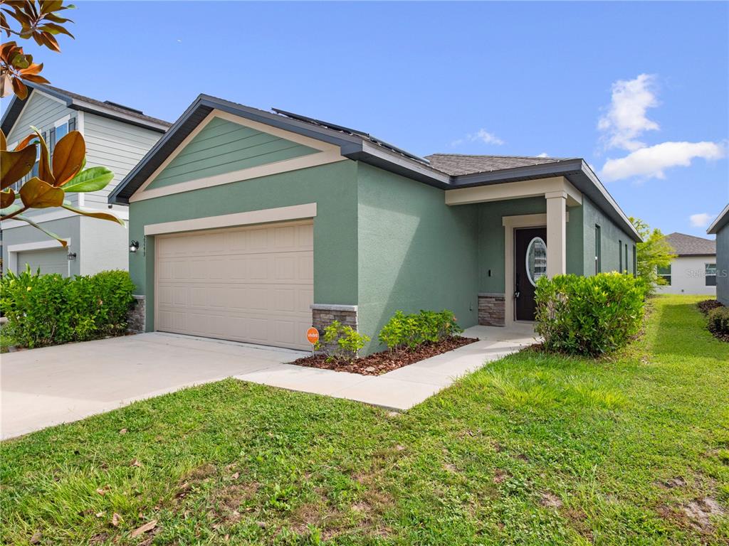2249 Litchfield Loop DeLand, FL 32720 - Photo 5 of 27 a front view of a house with a yard and garage