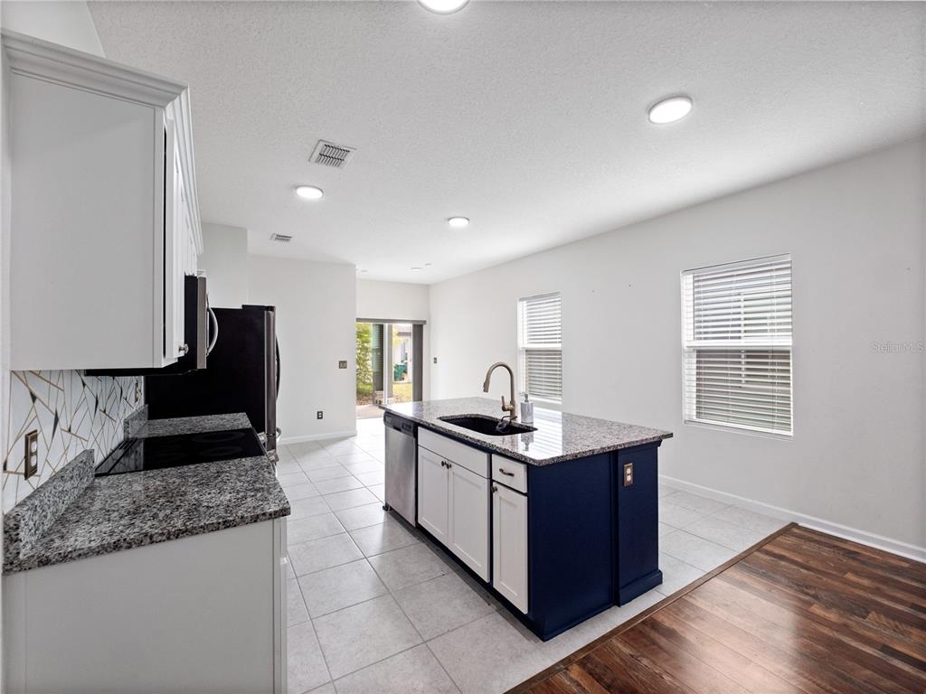 2249 Litchfield Loop DeLand, FL 32720 - Photo 10 of 27 a kitchen with granite countertop a sink and a stove top oven