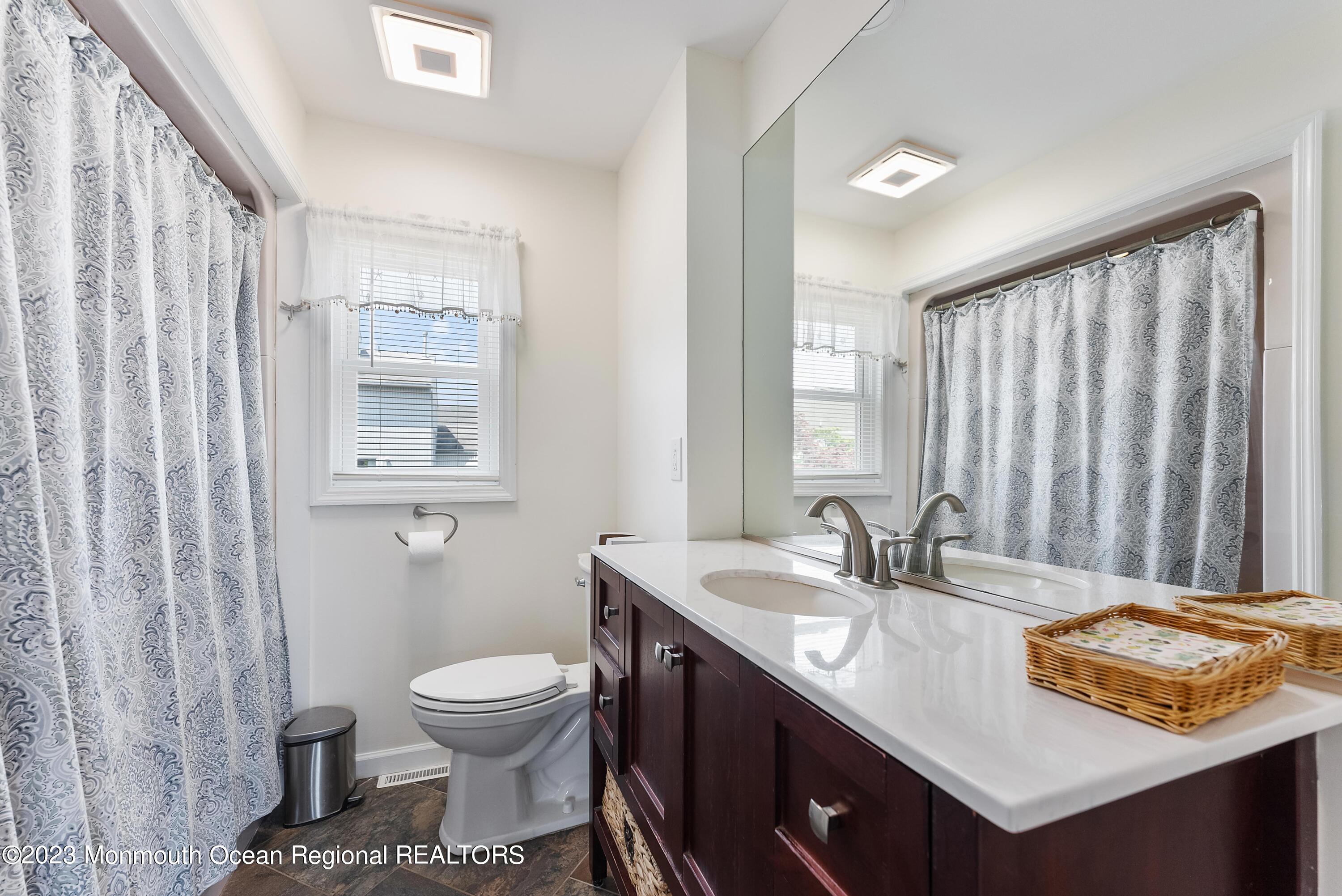 16 Brookfield Drive Brick, NJ 08723 - Photo 17 of 37 a bathroom with a sink toilet and mirror