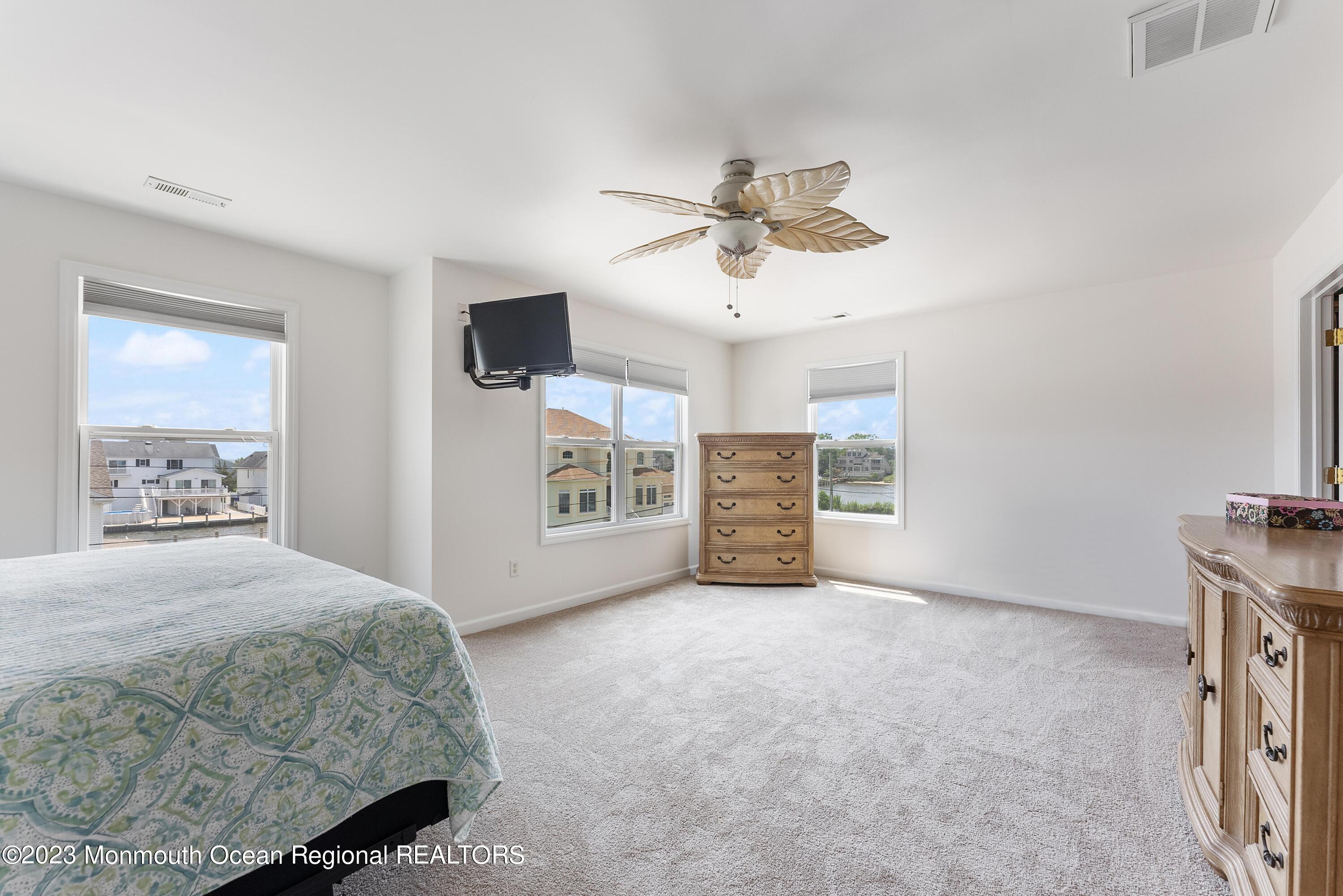 16 Brookfield Drive Brick, NJ 08723 - Photo 18 of 37 a spacious bedroom with a bed a ceiling fan and a dresser