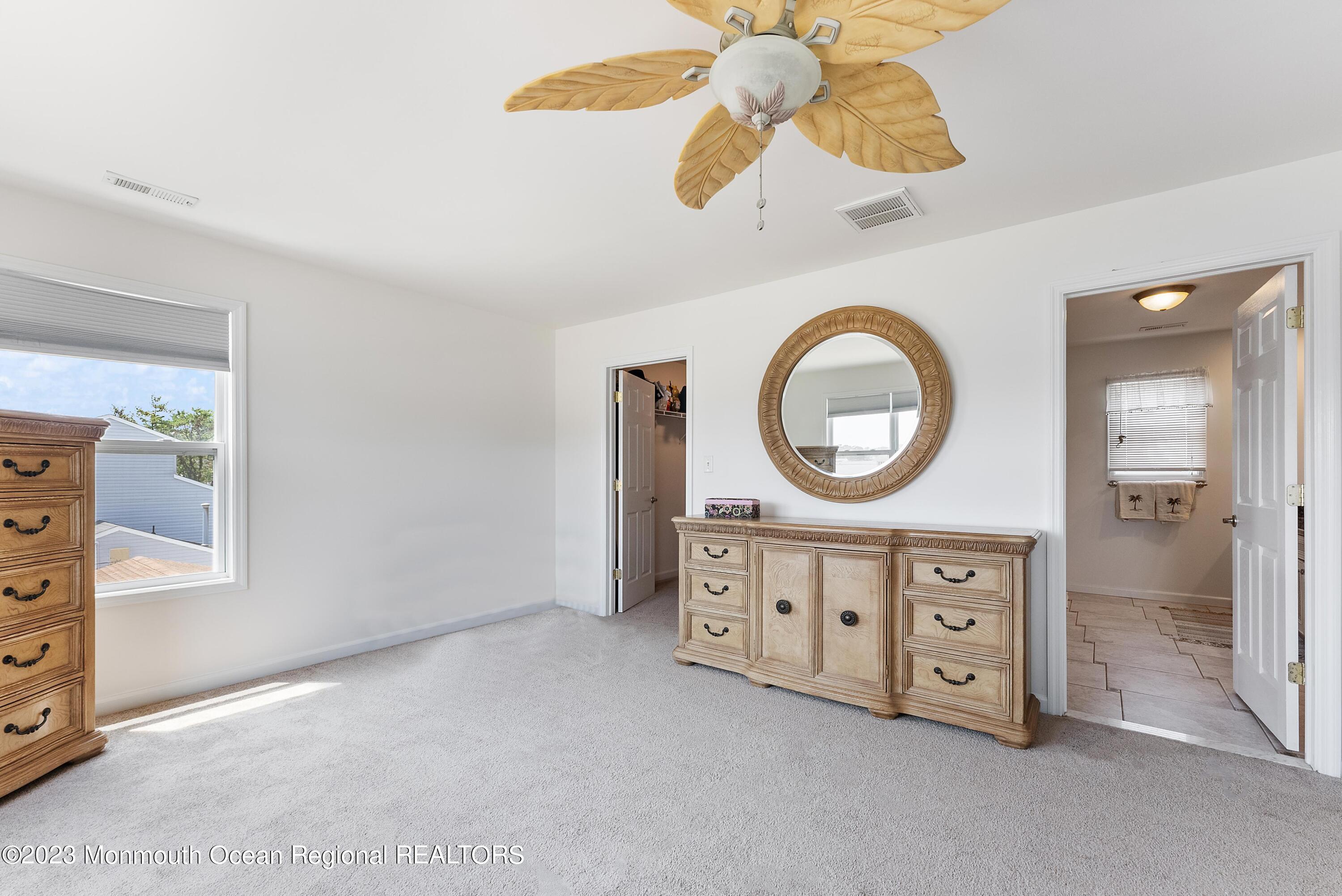 16 Brookfield Drive Brick, NJ 08723 - Photo 19 of 37 wooden floor with a dresser a mirror and a fan