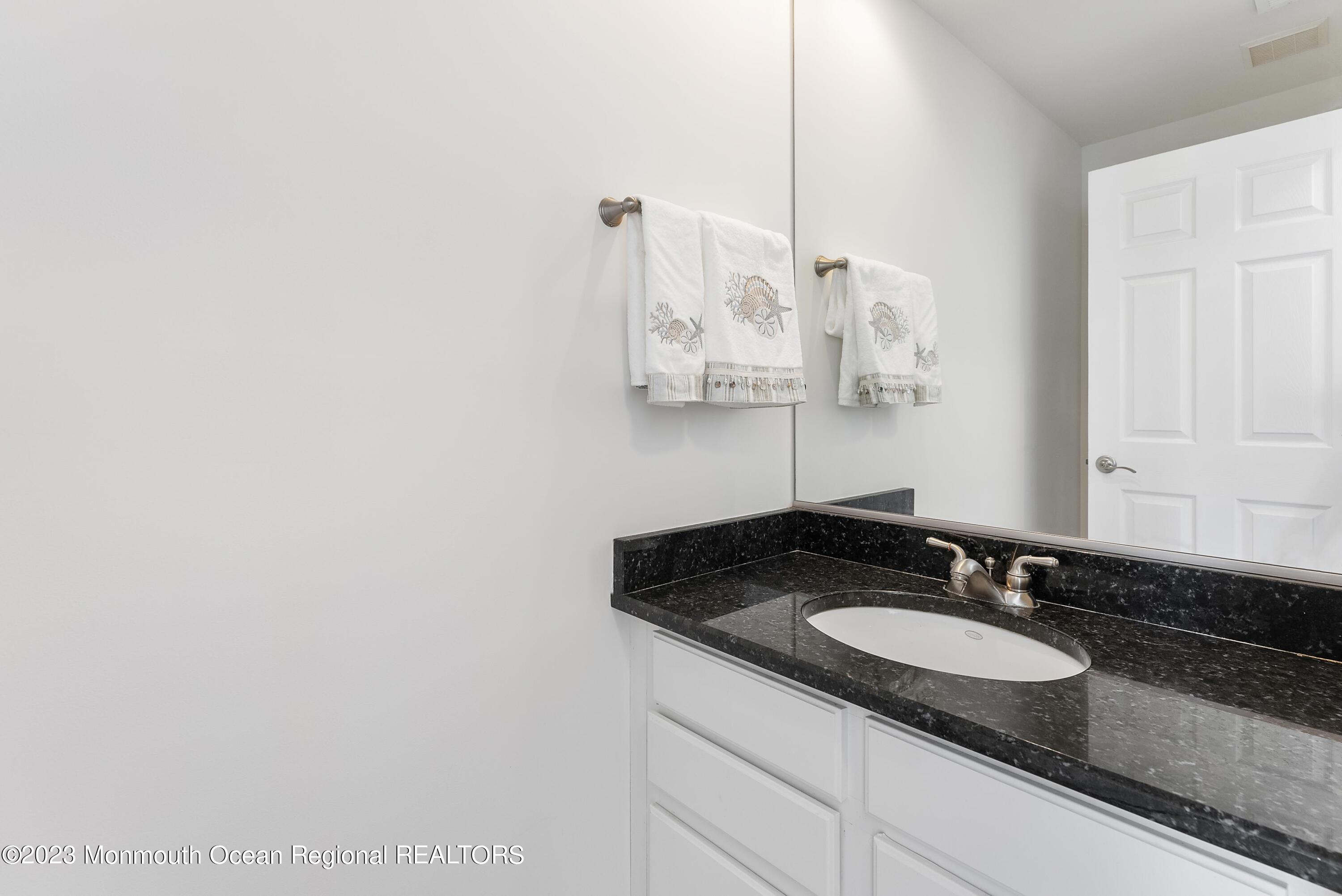 16 Brookfield Drive Brick, NJ 08723 - Photo 24 of 37 a bathroom with a sink and a mirror