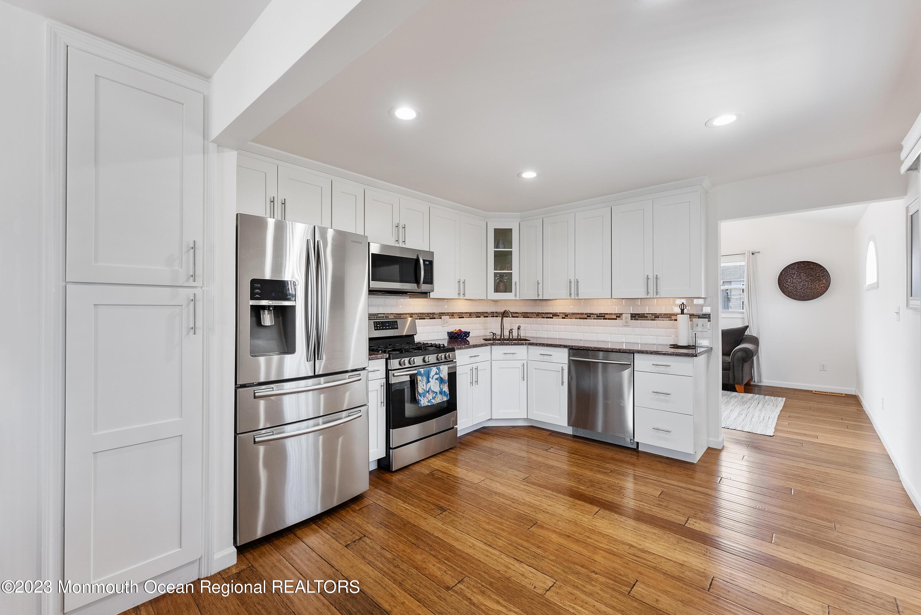 16 Brookfield Drive Brick, NJ 08723 - Photo 10 of 37 a kitchen with a refrigerator sink and cabinets
