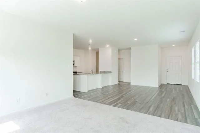 a view of kitchen and empty room