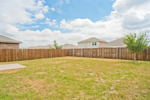 a view of a swimming pool with an outdoor space and wooden fence