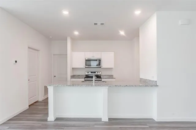 a kitchen with a sink cabinets and stainless steel appliances