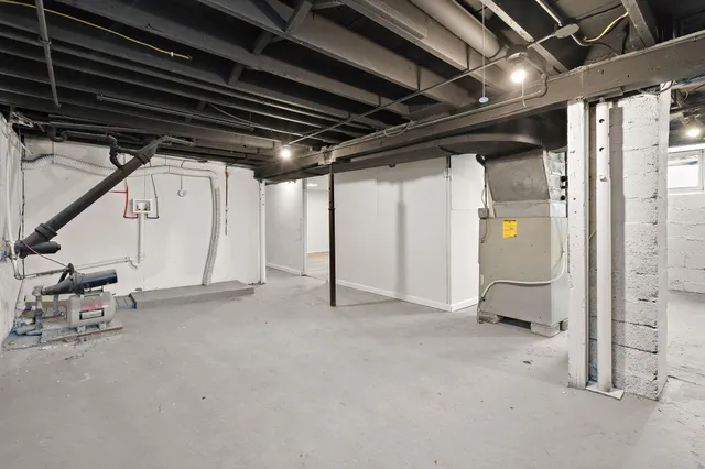 a view of water heater room with stairs
