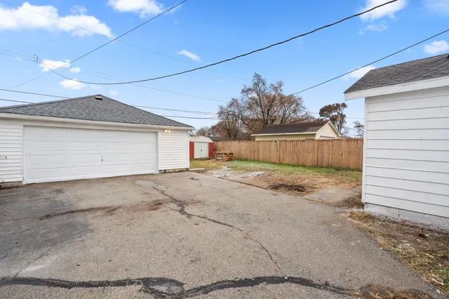 a view of a house with a yard and garage