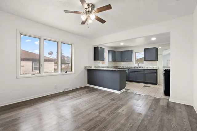a view of kitchen with granite countertop cabinets stainless steel appliances and a window