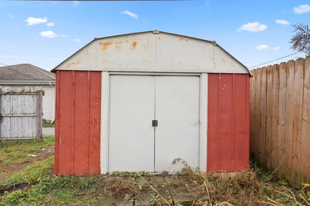 a view of a house with backyard and wooden fence