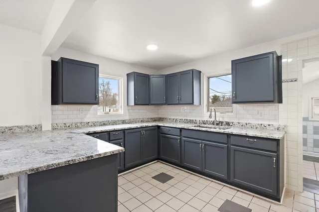 a kitchen with a sink and a stove top oven