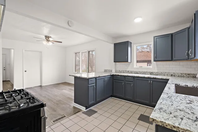 a kitchen with a sink stove and cabinets