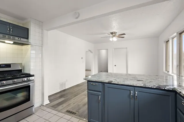 a kitchen with granite countertop cabinets stainless steel appliances and a window