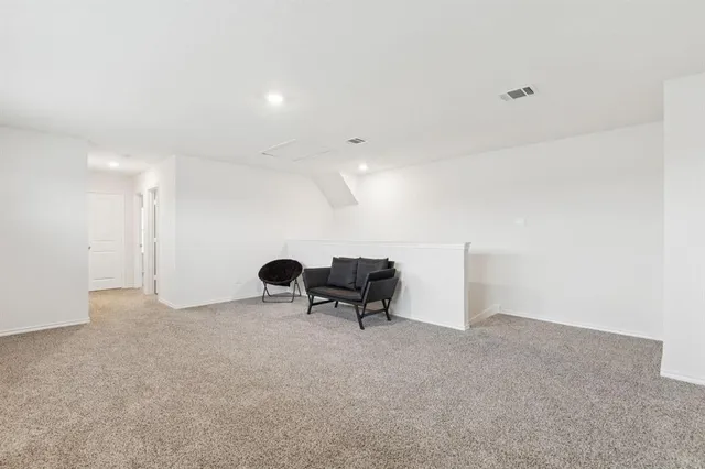 a view of an empty room with a bench