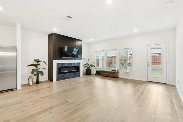 a view of a livingroom with an empty space and a fireplace