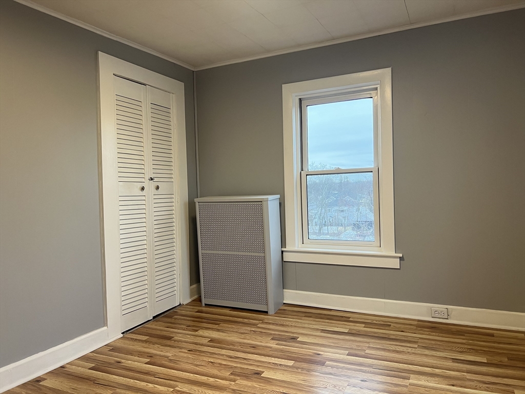 75 Sladen Street Dracut, MA 01826 - Photo 20 of 23 a view of an empty room with wooden floor and a window