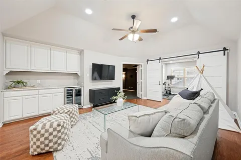 a living room with furniture and a flat screen tv