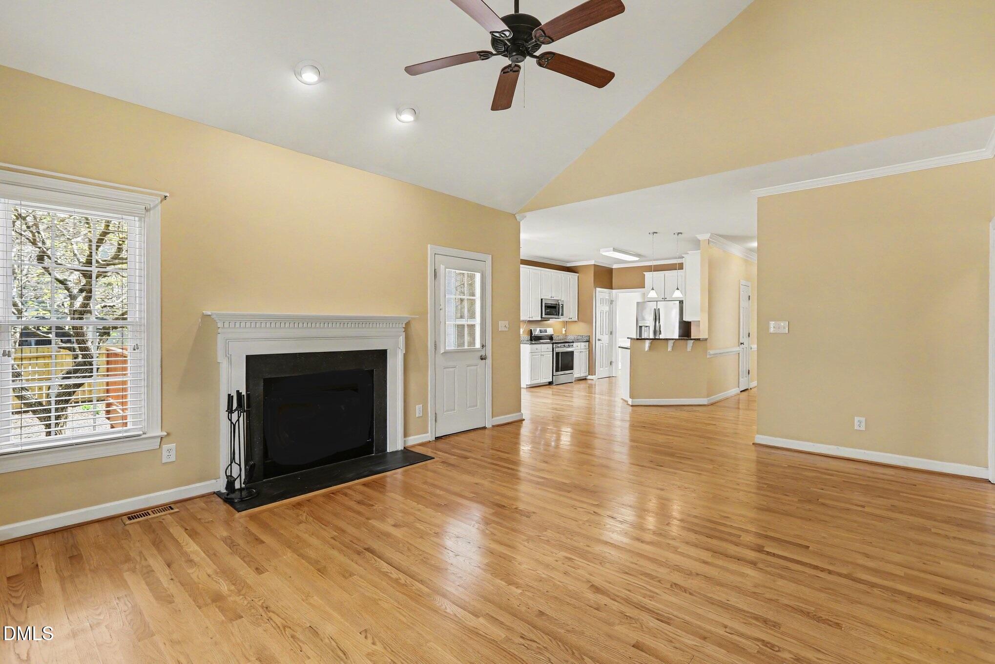 2616 Jasper Lane Raleigh, NC 27613 - Photo 10 of 44 a view of empty room with wooden floor and fireplace